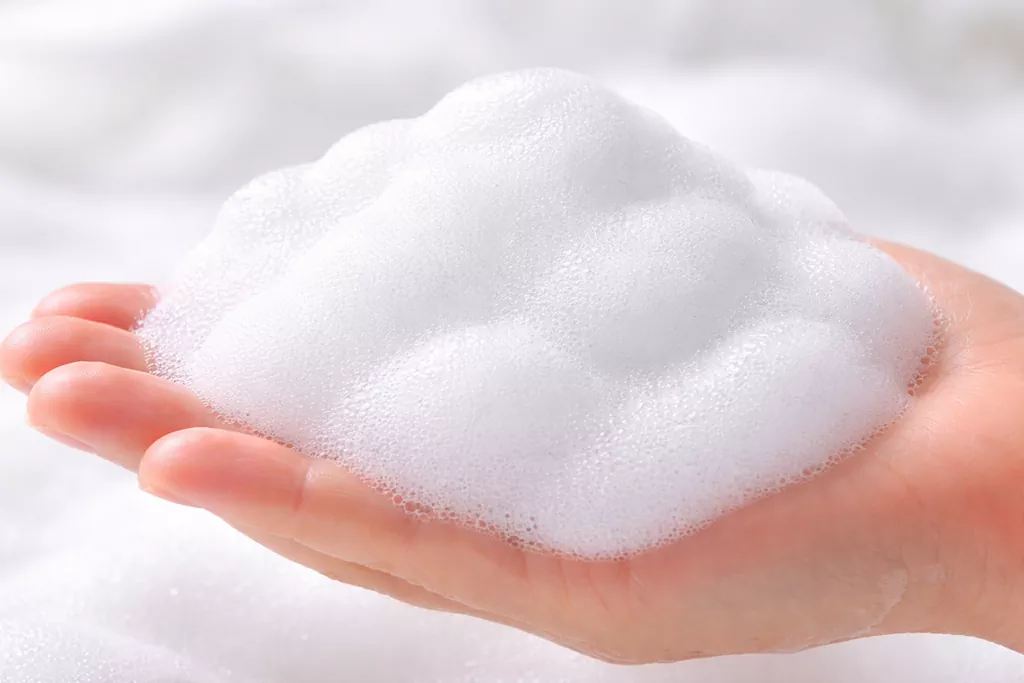 The Ultimate Gentle K Beauty Cleanser: Why Your Skin Barrier is Screaming for Help 1 Close-up of lush, dense white micro-foam from a Gentle K Beauty Cleanser on a hand, demonstrating its barrier-safe texture.